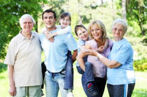 Portrait of a extended happy family standing in the park.