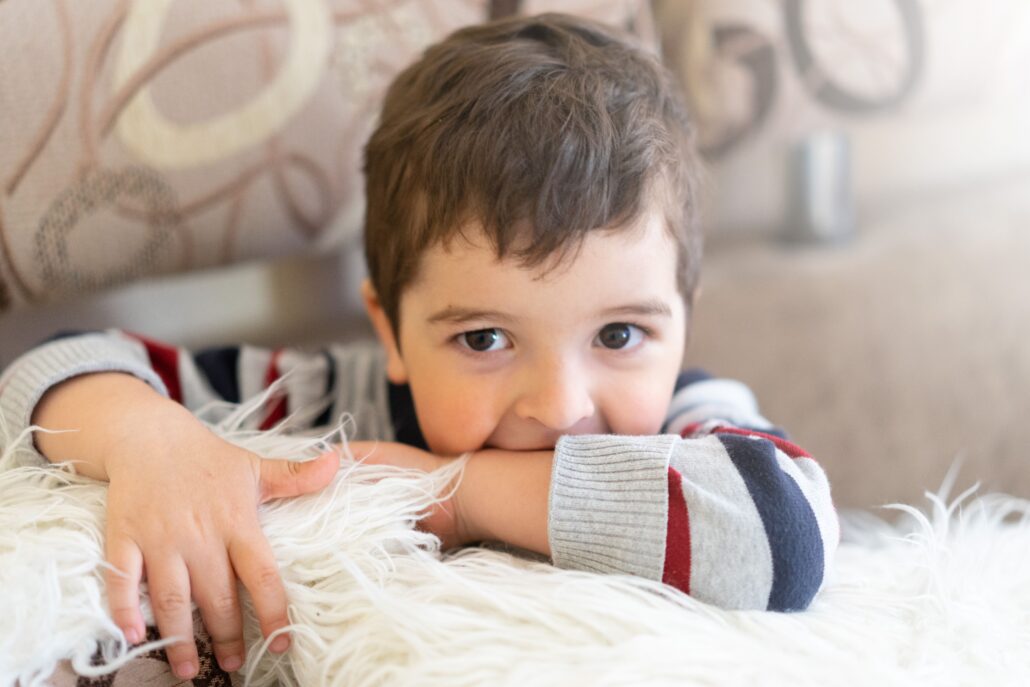 child with dysregulated nervous system leaning on chair