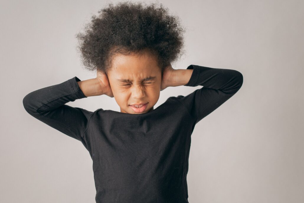 young child holding ears because of reoccurring ear infections and needs a natural substitute to getting tubes