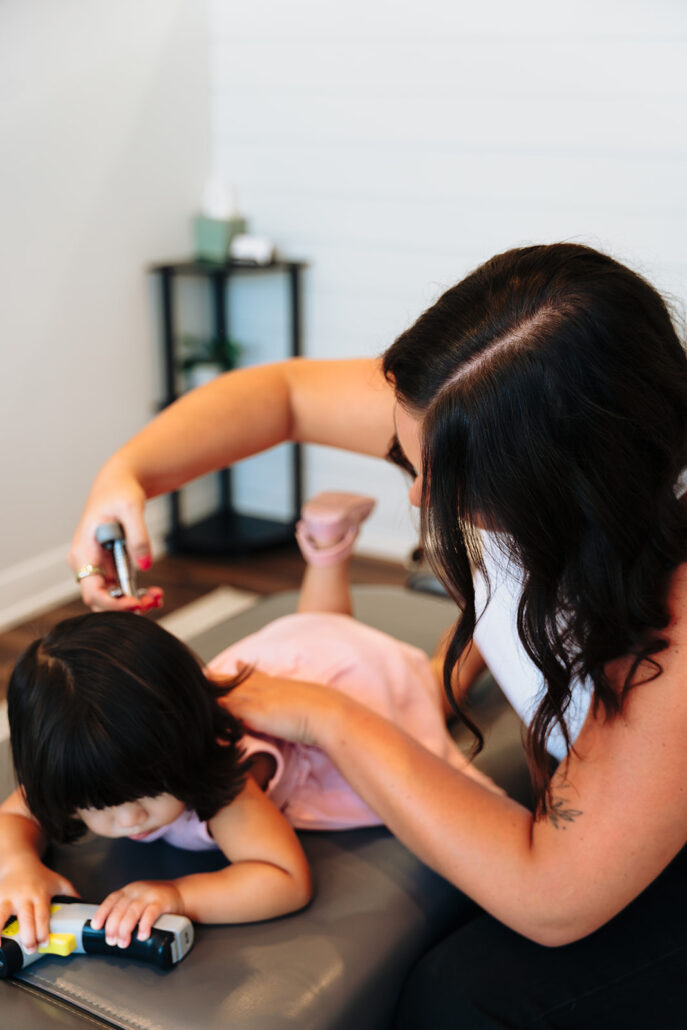Child positioned for a low-force pediatric adjustment at Blossom Family Chiropractic