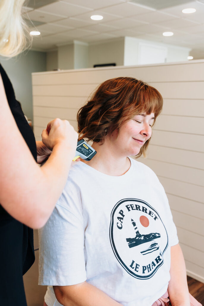 Chiropractor performing a targeted scan on a patient at Blossom Family Chiropractic