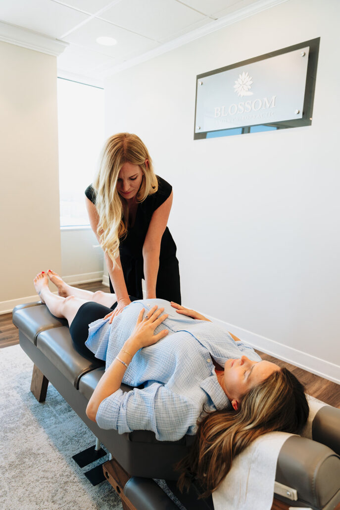 Dr. Savy assessing pelvic balance during a prenatal wellness visit